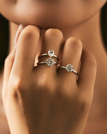 Three Solitaire Moissanite Rings – Round, Pear, and Cushion Cut