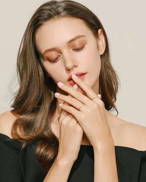 Model wearing dainty stacking rings together
