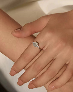Oval moissanite sterling silver ring worn on hand