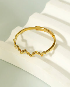 Stackable beaded adjustable gold ring close up
