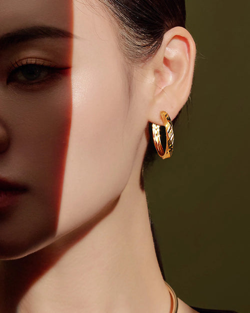 AriaEcho gold diamond cut hoop earrings on ear 18K gold plated sterling silver