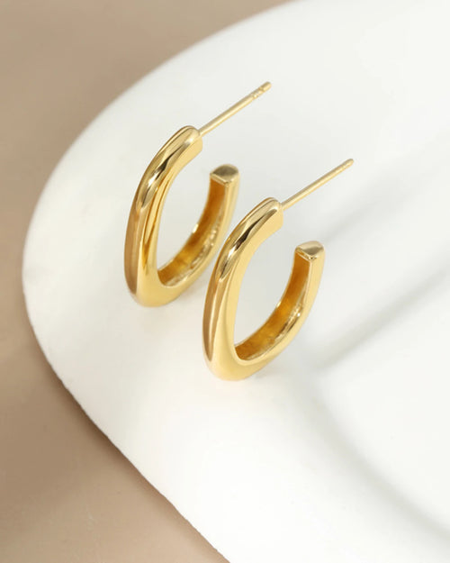 18K gold plated small hoop earrings displayed on ceramic surface minimalist style