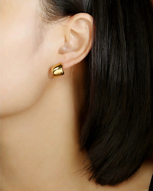 Modern gold stud earrings worn on model minimalist statement style