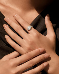 1ct emerald cut halo moissanite engagement ring worn on hand