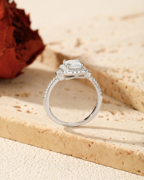close up of emerald cut halo moissanite engagement ring