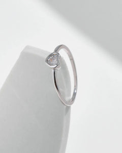 heart shape moissanite ring close-up on white surface