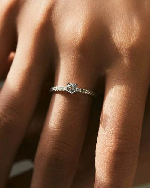 pavé solitaire ring on hand