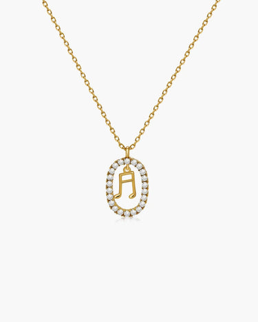 golden music note necklace with oval pendant on chain
