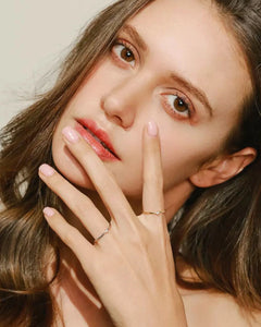 Elegant model wearing silver solitaire ring