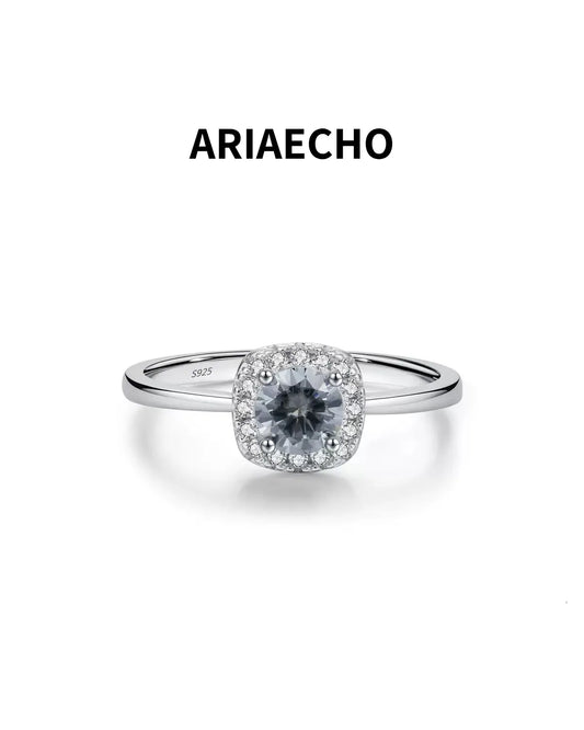 Gray moissanite cushion halo ring on white background