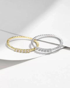 Minimalist moissanite rings photographed on white background