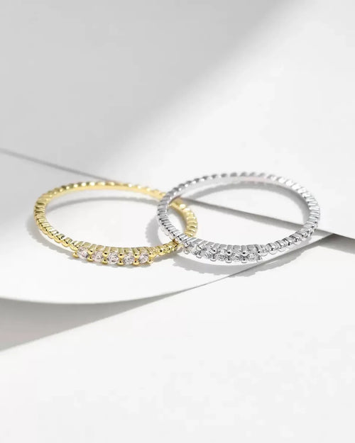 Minimalist moissanite rings photographed on white background