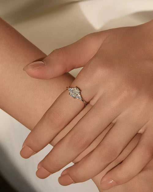 Oval moissanite sterling silver ring worn on hand