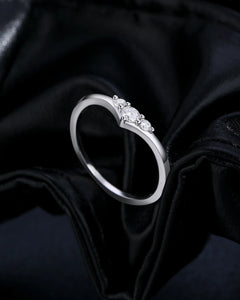 Side view of three-stone moissanite V-ring
