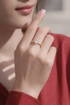 Woman wearing 18K gold 1ct moissanite solitaire ring close up