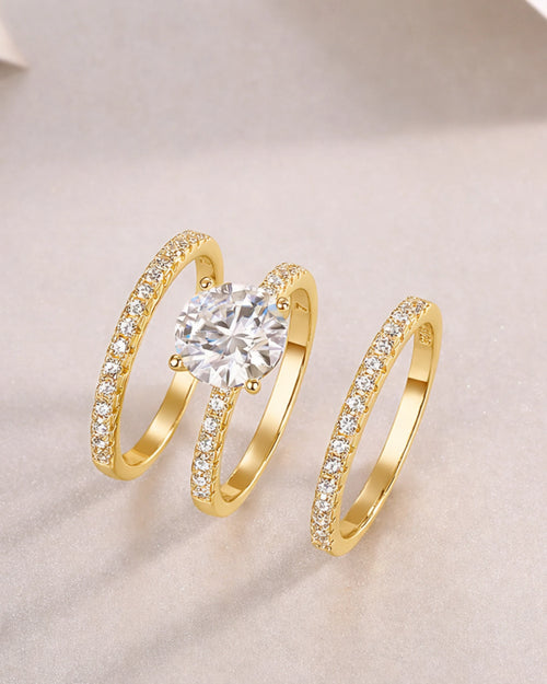 Side angle view of 18K gold plated moissanite wedding ring set with triple row pavé detailing