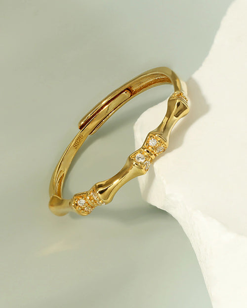 Modern bamboo gold open band ring with delicate crystal detail – angled view