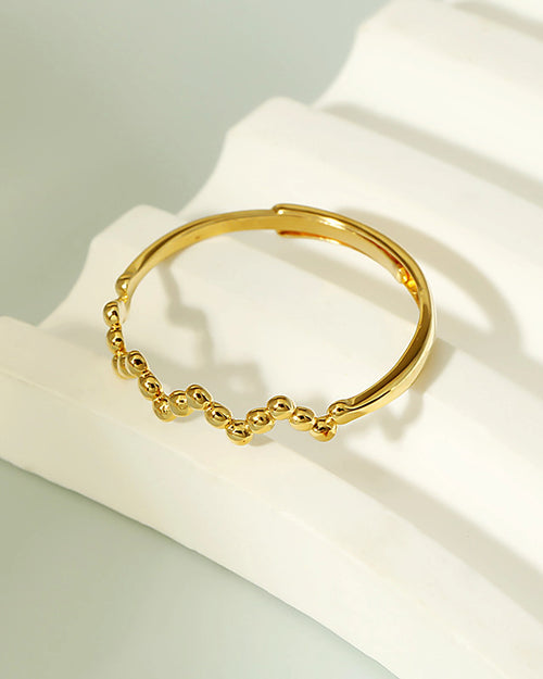 Stackable beaded adjustable gold ring close up