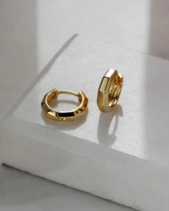 18K gold plated mini hoop earrings displayed on ceramic surface minimalist design