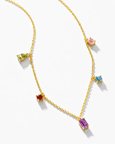 Model wearing dainty solitaire moissanite necklace