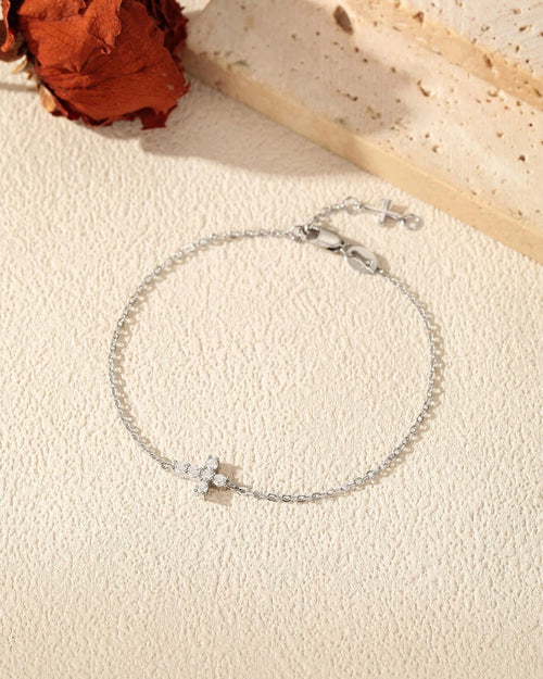 Flat lay of 925 sterling silver cross moissanite bracelet