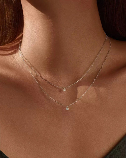 Model wearing dainty solitaire moissanite necklace