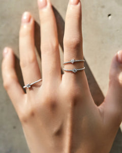 dainty moissanite beaded ring on model hand