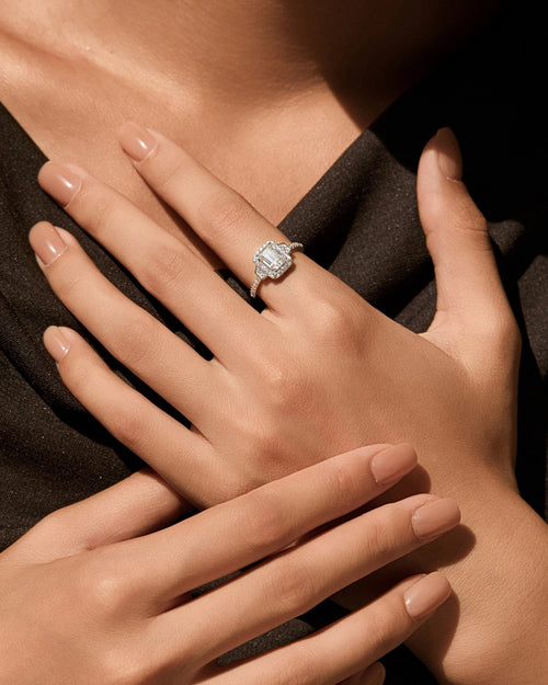 1ct emerald cut halo moissanite engagement ring worn on hand