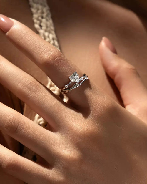 Model wearing heart moissanite ring in sterling silver