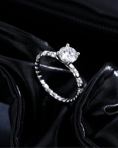 Front view of twisted solitaire moissanite engagement ring