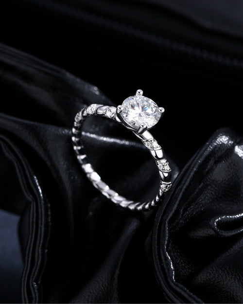 Front view of twisted solitaire moissanite engagement ring